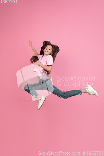 Image of Caucasian little girl portrait isolated on pink studio background, emotions concept