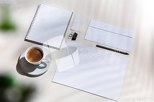 Image of Creative and cozy workplace at home office, inspirational mock up with plant shadows on table surface