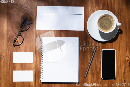 Image of Creative and cozy workplace at home office, inspirational mock up with plant shadows on table surface