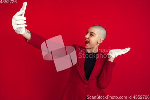 Image of Portrait of young caucasian bald woman on red background