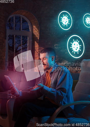 Image of Shocked, upset and sad man using gadgets to get information of coronavirus pandemic spread