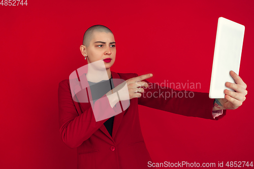 Image of Portrait of young caucasian bald woman on red background