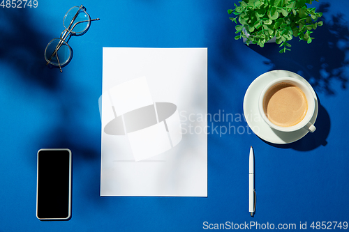 Image of Creative and cozy workplace at home office, inspirational mock up with plant shadows on table surface