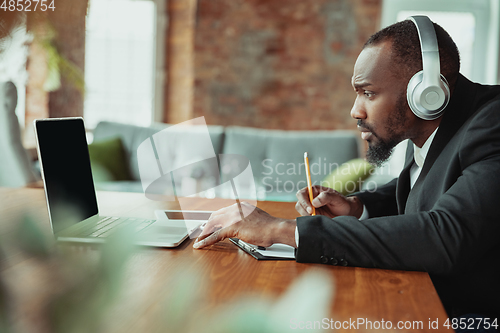 Image of Businessman or student working from home while being isolated or keep quarantine \'cause of coronavirus COVID-19