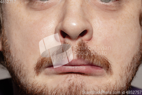 Image of Close-up male mouth illustrating emotions. Cosmetology, dentistry and beauty care, facial expression