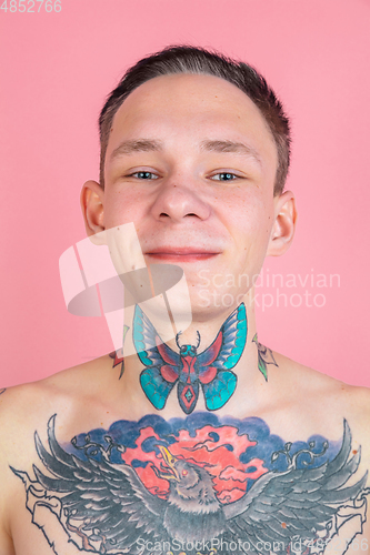 Image of Portrait of young man with freaky appearance on pink background