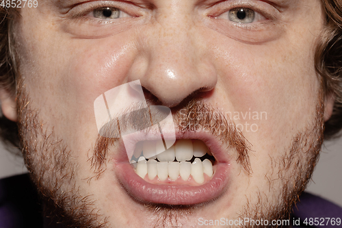 Image of Close-up male mouth illustrating emotions. Cosmetology, dentistry and beauty care, facial expression