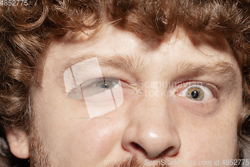 Image of Close up of face of beautiful caucasian young man, focus on eyes