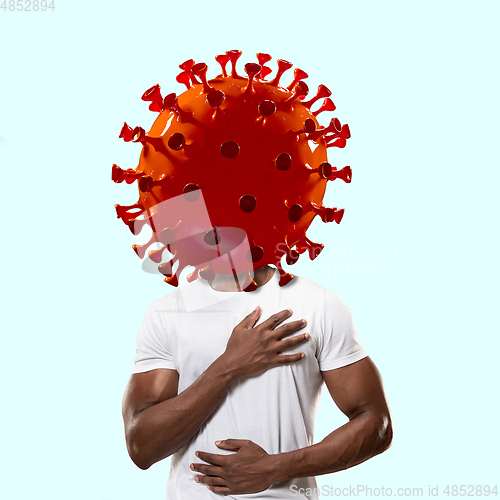 Image of Man headed by model of COVID-19 coronavirus, concept of pandemic spreading