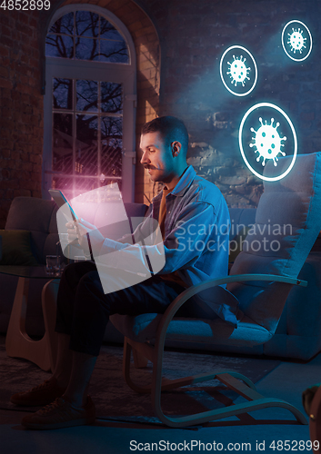 Image of Shocked, upset and sad man using gadgets to get information of coronavirus pandemic spread