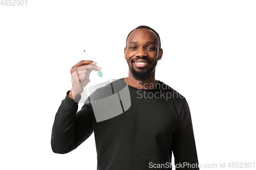 Image of How coronavirus changed our lives. Young man checking, taking temperature on white background