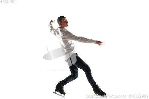 Image of Man figure skating isolated on white studio backgound with copyspace