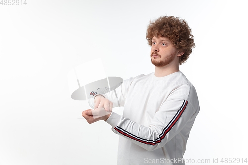 Image of How coronavirus changed our lives. Young man taking pulse on white background