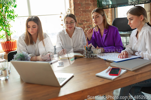 Image of Business young caucasian woman in modern office with team