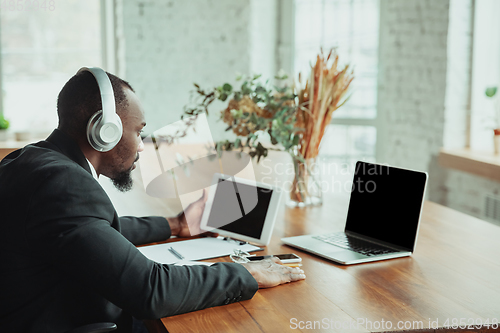 Image of Businessman or student working from home while being isolated or keep quarantine \'cause of coronavirus COVID-19