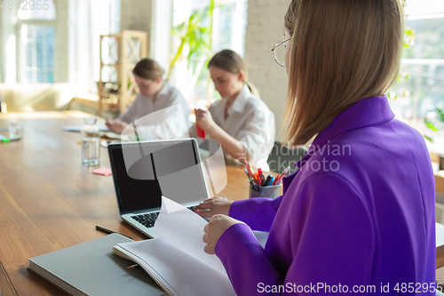 Image of Business young caucasian woman in modern office with team