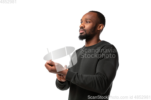Image of How coronavirus changed our lives. Young man taking pulse on white background