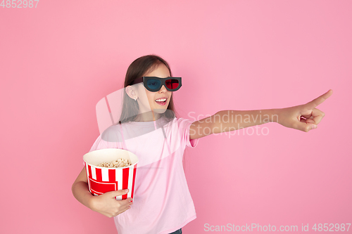 Image of Caucasian little girl portrait isolated on pink studio background, emotions concept