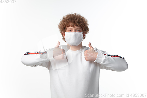 Image of How coronavirus changed our lives. Young man wearing face mask to stop spreading on white background