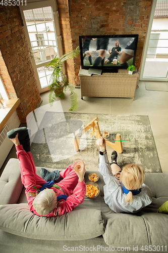 Image of Excited family watching football, sport match at home, grandma, mother and son