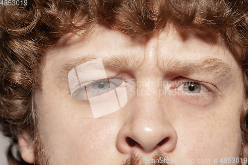 Image of Close up of face of beautiful caucasian young man, focus on eyes