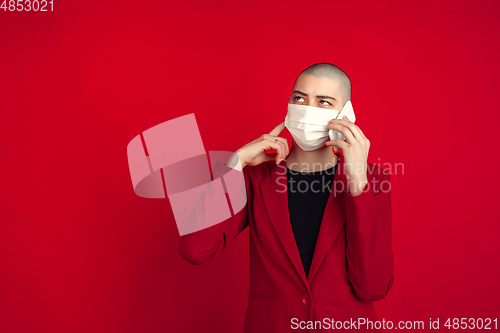 Image of Portrait of young caucasian bald woman on red background