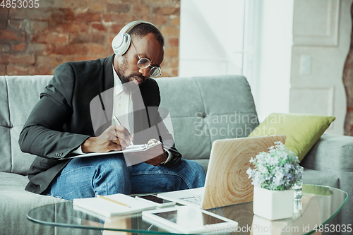 Image of Businessman or student working from home while being isolated or keep quarantine \'cause of coronavirus COVID-19