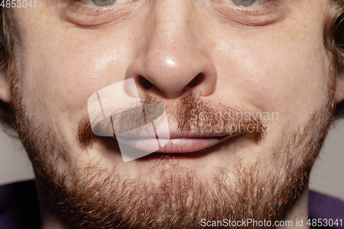 Image of Close-up male mouth illustrating emotions. Cosmetology, dentistry and beauty care, facial expression