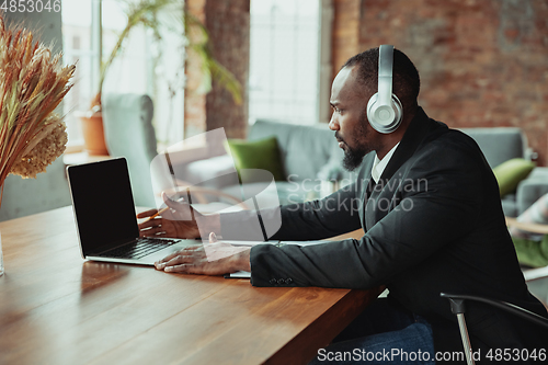 Image of Businessman or student working from home while being isolated or keep quarantine \'cause of coronavirus COVID-19