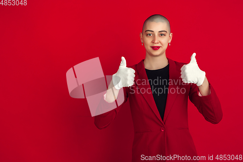 Image of Portrait of young caucasian bald woman on red background