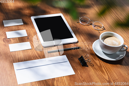 Image of Creative and cozy workplace at home office, inspirational mock up with plant shadows on table surface