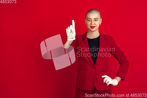 Image of Portrait of young caucasian bald woman on red background