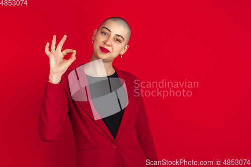 Image of Portrait of young caucasian bald woman on red background