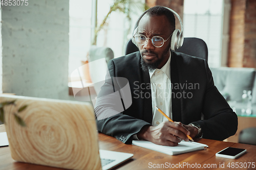 Image of Businessman or student working from home while being isolated or keep quarantine \'cause of coronavirus COVID-19