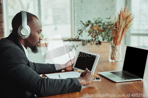 Image of Businessman or student working from home while being isolated or keep quarantine \'cause of coronavirus COVID-19