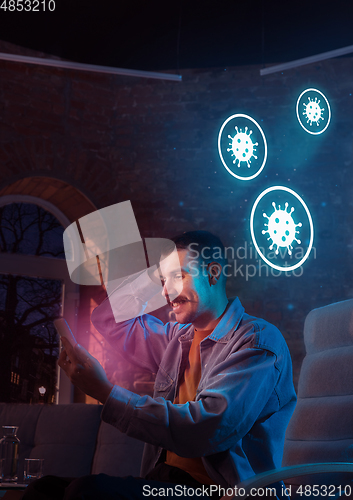 Image of Shocked, upset and sad man using gadgets to get information of coronavirus pandemic spread