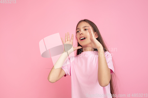 Image of Caucasian little girl portrait isolated on pink studio background, emotions concept