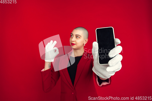 Image of Portrait of young caucasian bald woman on red background