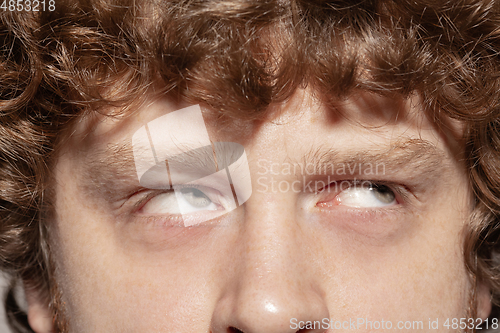 Image of Close up of face of beautiful caucasian young man, focus on eyes