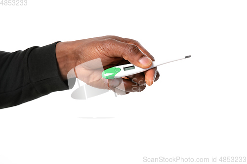 Image of How coronavirus changed our lives. Close up of male hands holding thermometer, taking temperature on white background