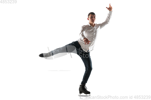 Image of Man figure skating isolated on white studio backgound with copyspace