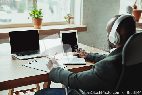 Image of Businessman or student working from home while being isolated or keep quarantine \'cause of coronavirus COVID-19