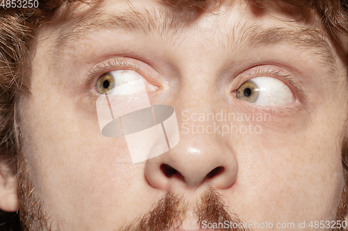 Image of Close up of face of beautiful caucasian young man, focus on eyes