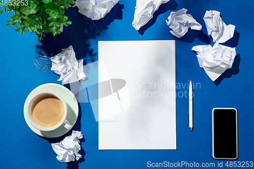 Image of Creative and cozy workplace at home office, inspirational mock up with plant shadows on table surface