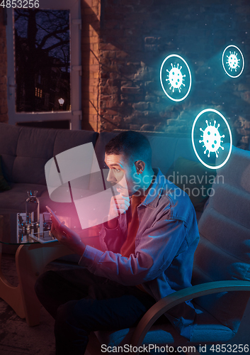 Image of Shocked, upset and sad man using gadgets to get information of coronavirus pandemic spread