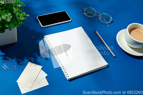 Image of Creative and cozy workplace at home office, inspirational mock up with plant shadows on table surface