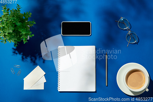 Image of Creative and cozy workplace at home office, inspirational mock up with plant shadows on table surface