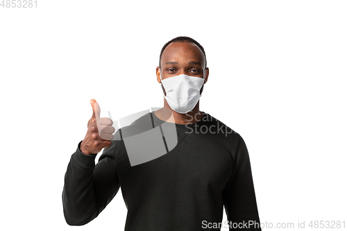 Image of How coronavirus changed our lives. Young man wearing face mask to stop spreading on white background