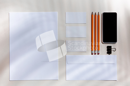 Image of Creative and cozy workplace at home office, inspirational mock up with plant shadows on table surface