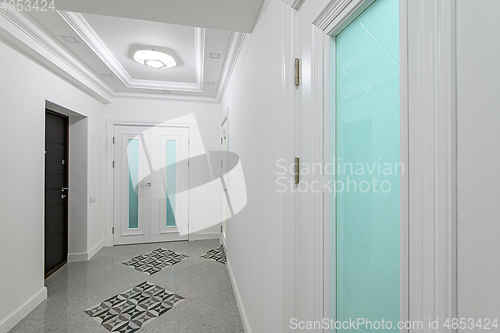 Image of interior of white hallway with doors